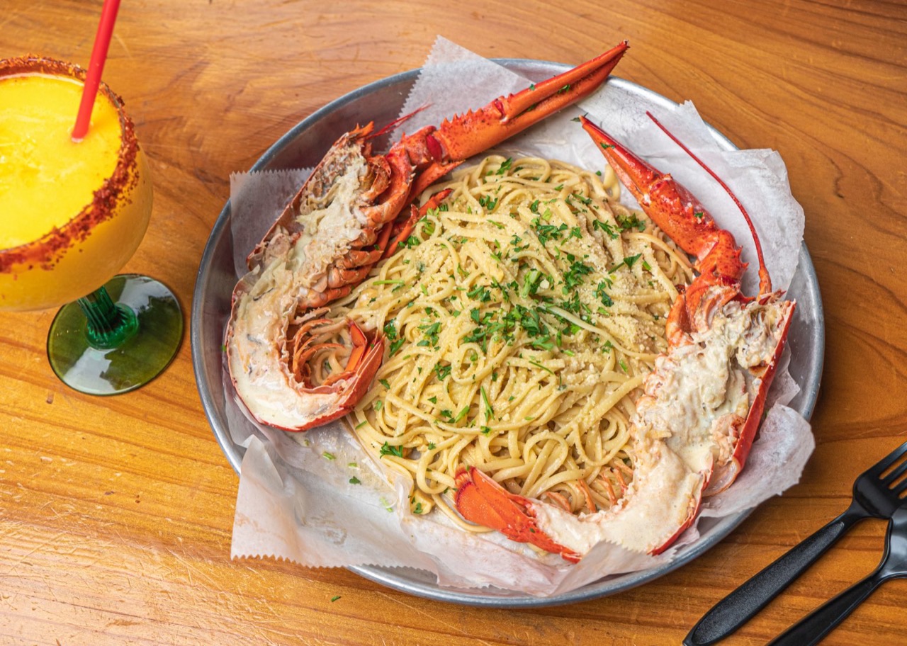 A Crab Bay seafood boil bag with crab, shrimp, corn, and potatoes